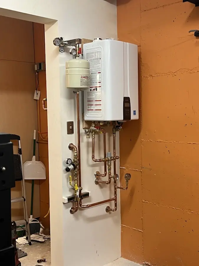 Plumbing technician inspecting water heater connections in Palos Verdes Estates
